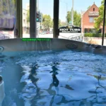 pasadena 18 hot tub with water fall in window display of showroom