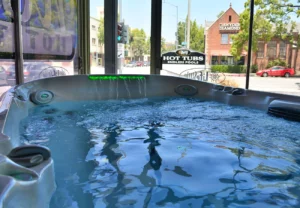 pasadena 18 hot tub with water fall in window display of showroom