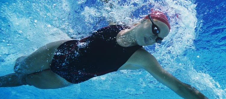 swimmer learning and perfecting her stroke in an endless pool in pasadena