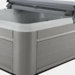 lifestyle outdoor hot tub with gray siding and open cover.