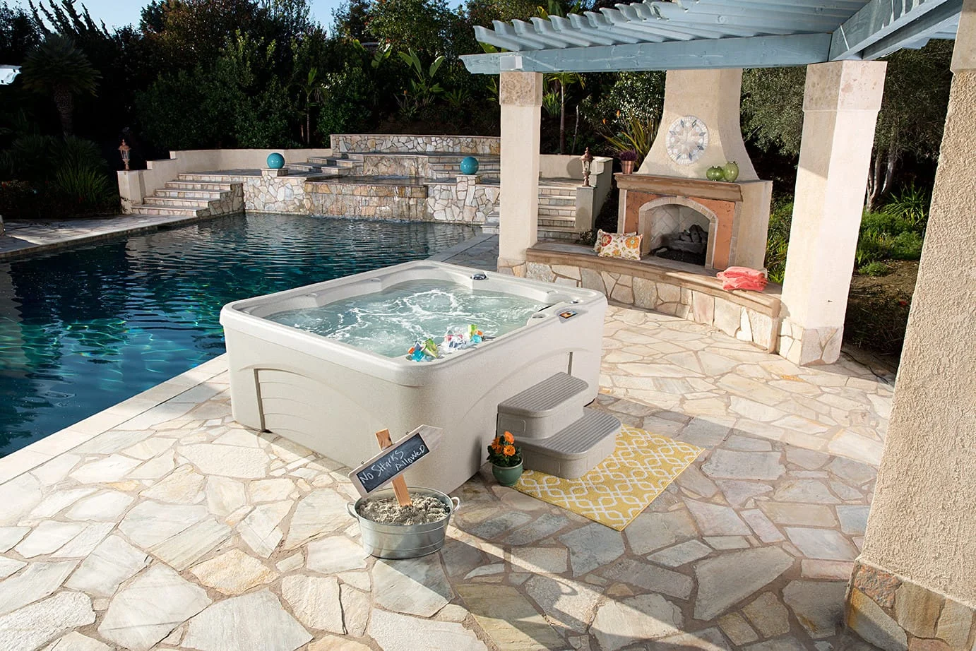 Fantasy Entice hot tub by Lifestyle Outdoor on a stone patio.
