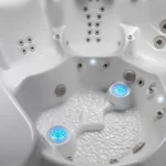 lifestyle outdoor hot tub interior with blue lights and bubbles.