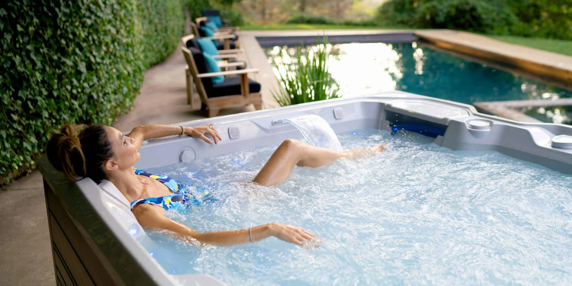 woman lounging in a bubbling lifestyle outdoor hot tub.