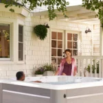 couple enjoying a lifestyle outdoor hot tub on a charming porch.