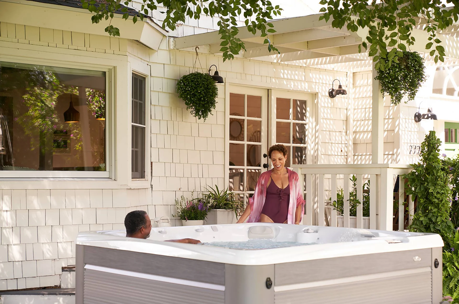 couple enjoying a lifestyle outdoor hot tub on a charming porch.