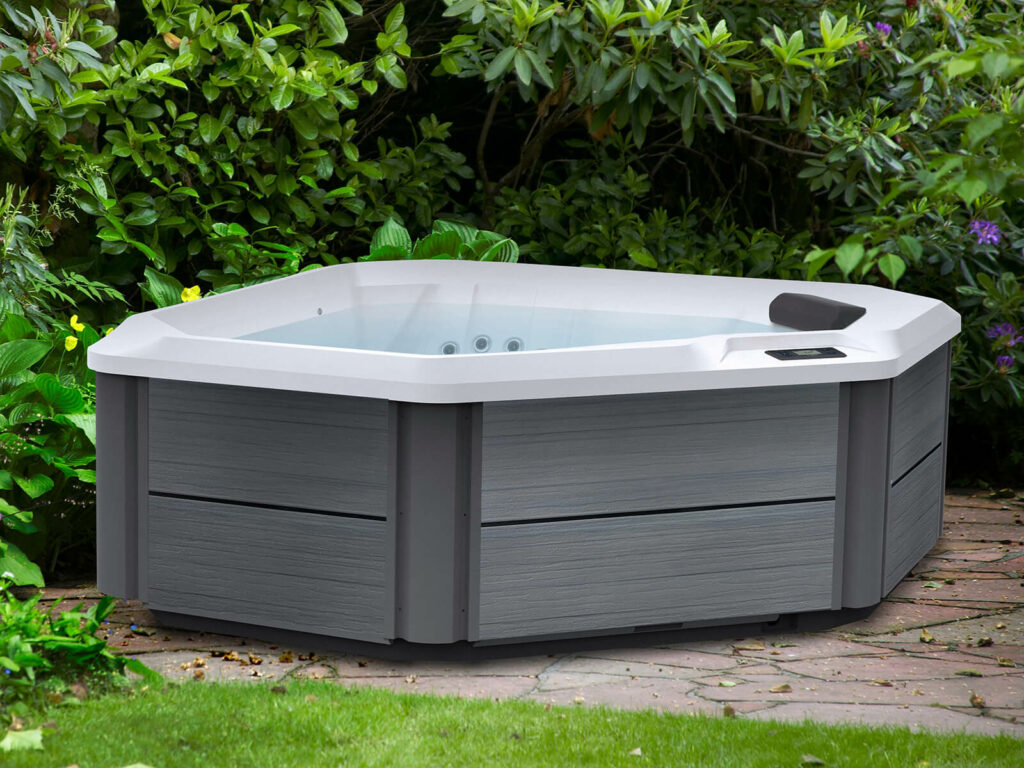 outdoor hot tubs - triangular hot tub surrounded by plants