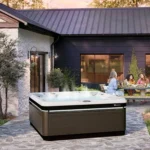 caldera spas utopia series a spot geneva java arctic white lifestyle sunset group behind spa