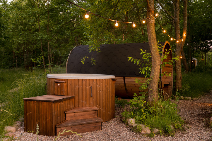 outdoor sauna and hot tub in a backyard